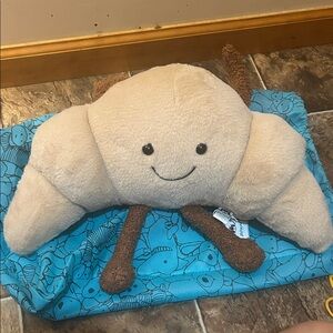 Smiling Plush Croissant Pillow in Light Beige